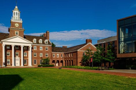 Watson Hall and Rockwell Integrated Sciences Center beneath a bright blue sky