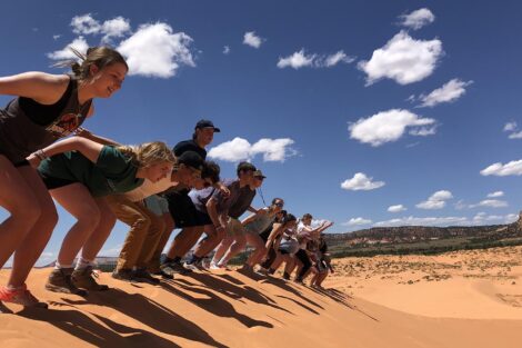 Students pose at the edge of a canyon on the Summer 2022 geology trip