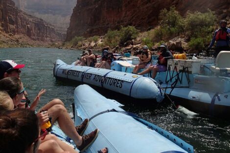 students sit in river rafts in Grand Canyon