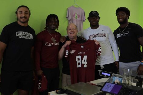 Lafayette football players Marco Olivas, Malik Hamm, Nahjee Adams, and Jyaire Stevens surprising the owner of Just a Dream frozen yogurt shop with a Lafayette jersey
