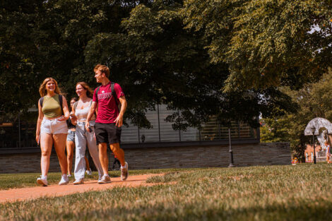 Students walk on a brick path on the Quad.