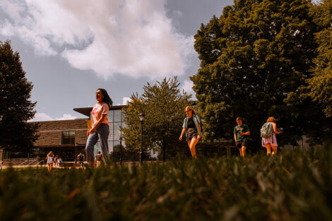 Students walk on a brick path on the Quad.