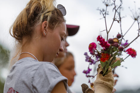 a student creates a flower bouquet