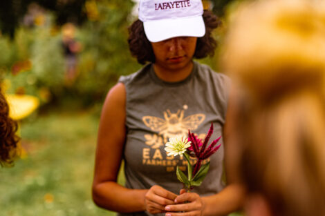 a student creates a flower bouquet