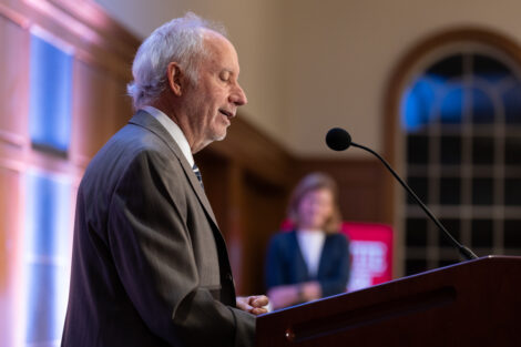 Jeffrey Acopian ’75 P’19 is standing at a podium. He is wearing a dark suit jacket.
