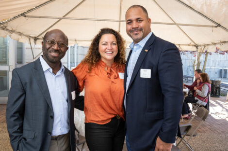 From left to right, Rexford Ahene, Jenny Miller, and Quincy Miller 97 are standing outside at the Volunteer Awards.