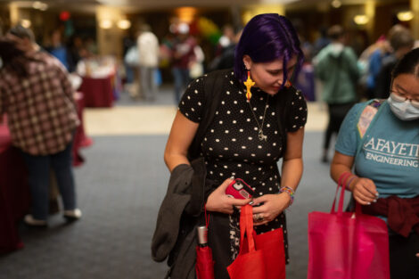 Two students visit the the National Coming Out Day Celebration and Resource Fair.
