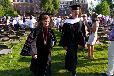 President Nicole Farmer Hurd walks with Chip Bergh in regalia at Commencement.